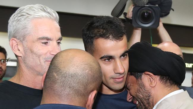 Foster and Hakeem are greeted at Melbourne airport. Picture: Getty