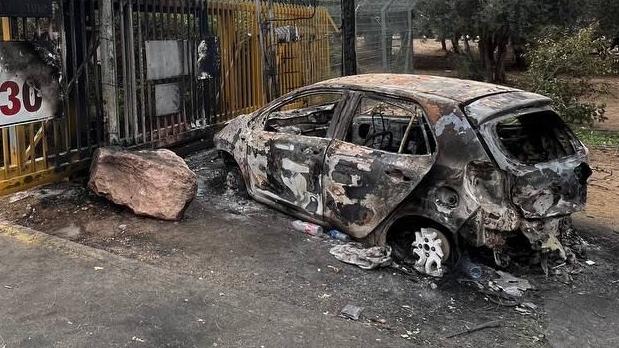 A torched car that crashed into the front gate of Kibbutz Be’eri.