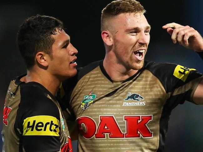 SYDNEY, NEW SOUTH WALES - APRIL 03: Bryce Cartwright of the Panthers celebrates with team mate Dallin Watene-Zelezniak after scoring the winning try during the round five NRL match between the Parramatta Eels and the Penrith Panthers at Pirtek Stadium on April 3, 2016 in Sydney, Australia. (Photo by Brendon Thorne/Getty Images)