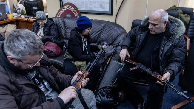 Home guard: Civilian volunteers check their guns at a Territorial Defence unit registration office in Kyiv. Picture: Getty Images