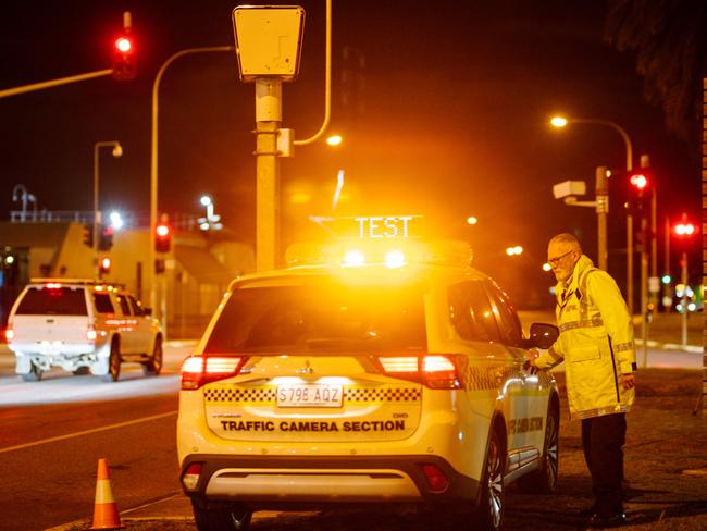 SA Police’s traffic branch check red-light cameras at the intersection of Grand Junction and Commercial roads in Port Adelaide on Thursday night. Picture: The Advertiser/ Morgan Sette