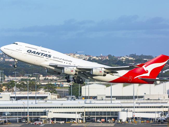 Sydney, Australia - Qantas Longreach 747 VH-OJT "Fraser Island"  aircraft taking off from Sydney Airport, with domestic terminal in background.