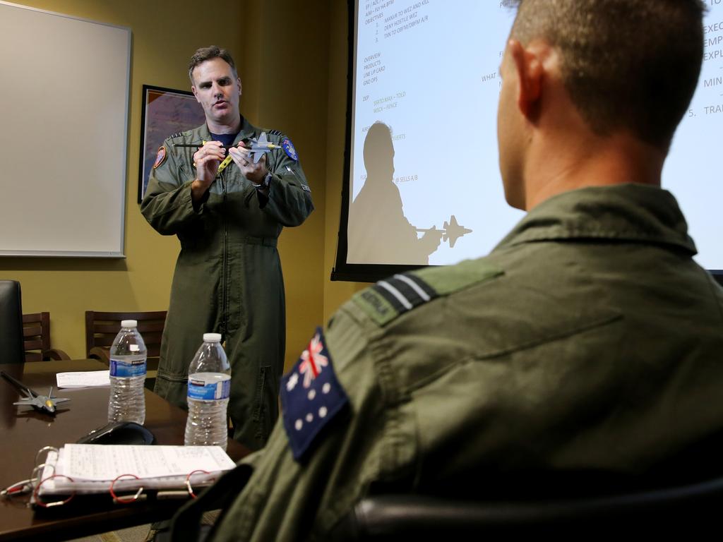 Australian Pilots training in the F35 fighter Jets Luke Airforce Base in Phoenix Arizona. Squadron leader Wing Commander Darren Clare (L) briefs Flight Lieutenant “Damo” before a flight . Picture: Nathan Edwards
