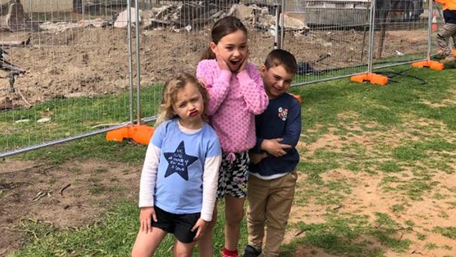 Mrs Thompson's grandchildren watching their beloved riverfront property being demolished after the floods. Picture: Supplied