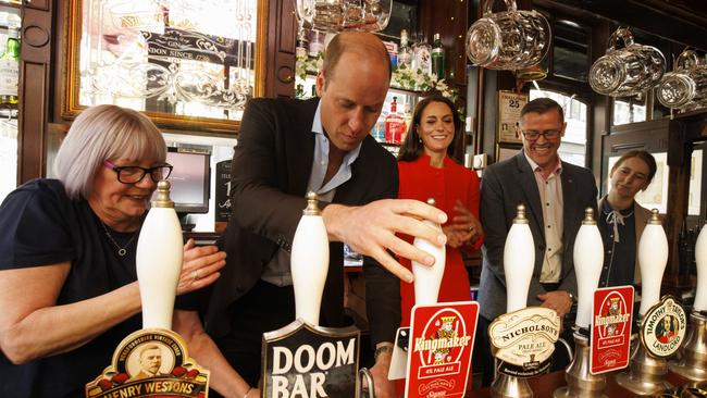 Prince William pulls the first pint of Kingmaker a new brew celebrating the coronation as Catherine, Princess of Wales looks on at the Dog and Duck pub in Soho. Picture: WPA Pool/Getty Images.