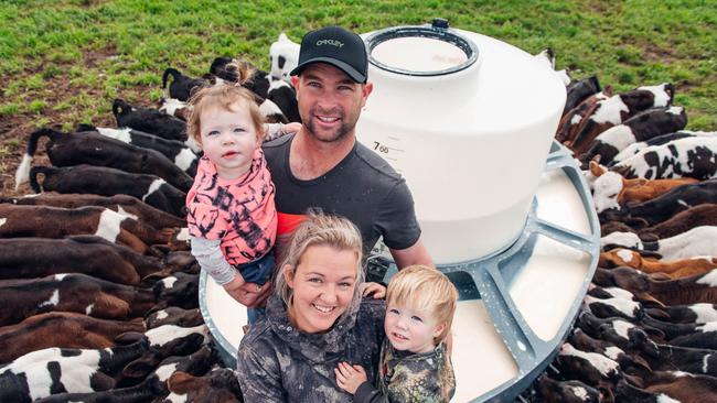 Nicole and Brendan Saunders on their Maffra dairy farm with their children Jaxson, 2, and Kara, 1. The employee in one of the pictures with Nicole is Jasper Manuel. Pictures: Laura Ferguson