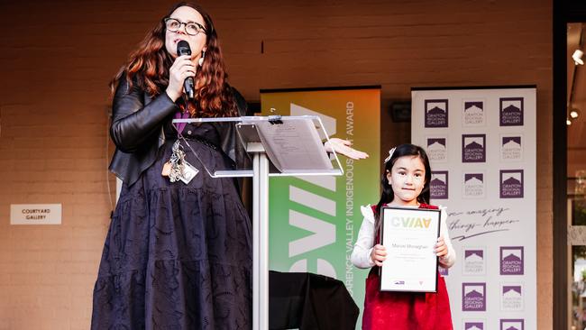 Maisie Monaghan receiving her Youth award from Gallery director Niomi Sands.