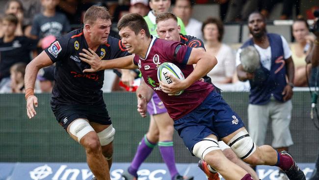 Harry Hockings pushes away from the Sharks defence.