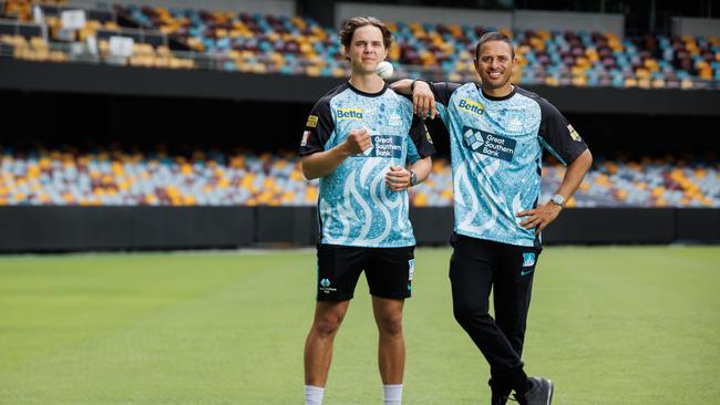 Brisbane Heat players Mitch Swepson and Usman Khawaja at the Gabba before their opening round game against the Melbourne Stars. Picture Lachie Millard