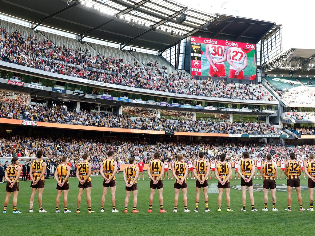 MELBOURNE, AUSTRALIA - APRIL 28: The Hawks pause for the Last Post during the 2024 AFL Round 07 match between the Hawthorn Hawks and the Sydney Swans at the Melbourne Cricket Ground on April 28, 2024 in Melbourne, Australia. (Photo by Michael Willson/AFL Photos via Getty Images)