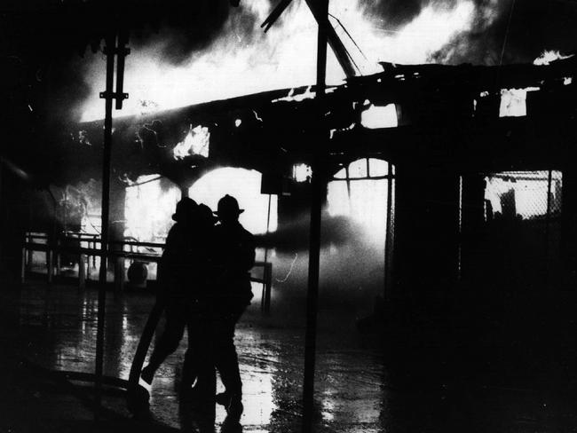 Firemen fight the deadly Ghost Train fire which was started by an electrical fault at Luna Park in 1979.