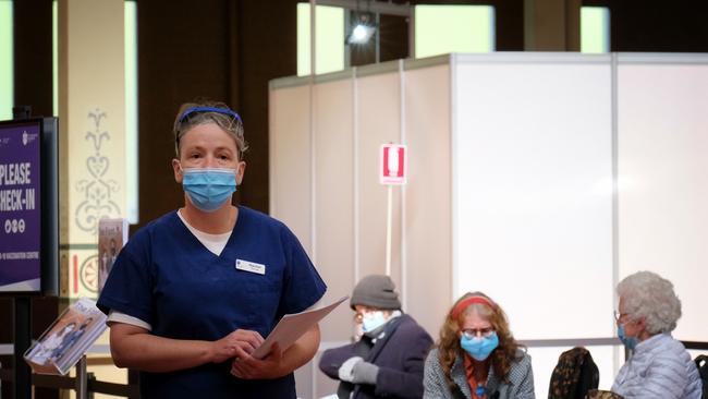 People wait for their vaccination at the Carlton hub. Picture: Getty Images