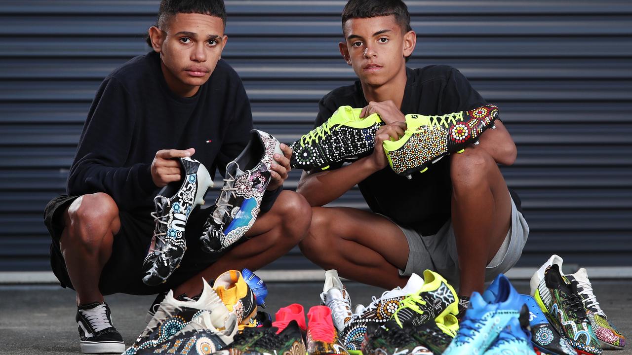 Indigenous children show off the football boots which will be worn by NRL players ahead of the NRL's upcoming Indigenous Round. Picture: Richard Dobson