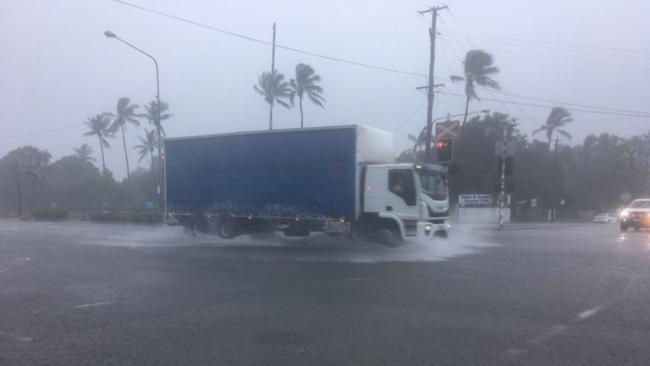 A truck crosses the flooded road as the deluge sets in across Townsville on Friday, January 31.