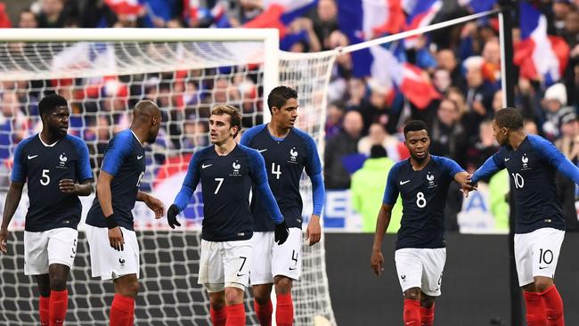 France's midfielder Thomas Lemar (2nd R) celebrates with teammates after scoring a goal