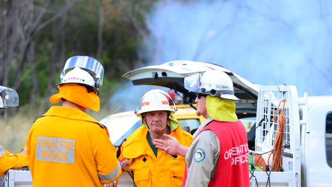 Rural Fire Service Queensland and QPWS Queensland Parks and Wildlife Service on scene at a previous controlled burn. Picture: Sharyn O'Neill