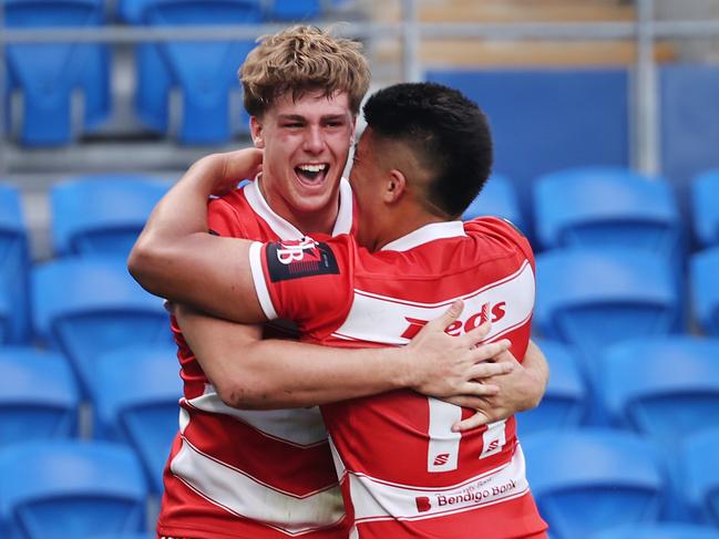 NRL National Schoolboys Cup final at CBUS Stadium  between Palm Beach Currumbin and Patrician Blacktown Brothers. The Red Army and Palm Beach Currumbin 's Beau Hartmann scores the winning try and  celebrates with team mates..  .Picture Glenn Hampson