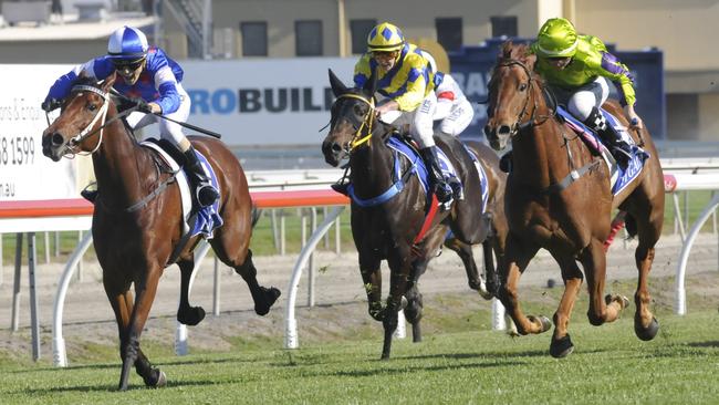 Jockey Melinda Graham makes it a family affair as she wins on Masked Model at the Gold Coast for her father, Murwillumbah trainer Darren. Pictures: TRACKSIDE PHOTOGRAPHY/JESSICA HAWKINS