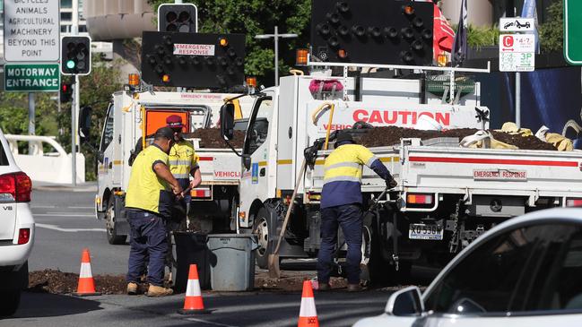 Workers clean up almost a tonne of manure that was dumped outside Parliament House in the Brisbane CBD. Picture: Peter Wallis