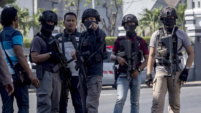 Police outside the Surabaya police headquarters in Indonesia yesterday after a blast carried out by a family of five, including an eight-year-old girl. Picture: Getty Images