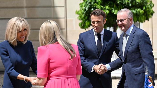 France's President Emmanuel Macron (2R) shakes hands with Australia's Prime Minister Anthony Albanese (R) as Emmanuel Macron's wife Brigitte Macron (L) shakes hands with Anthony Albanese's partner Jodie Haydon (2L) on July 1, 2022. Picture: Emmanuel Dunand/AFP