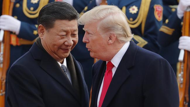 U.S. President Donald Trump, right, chats with Chinese President Xi Jinping. (AP Photo/Andy Wong, File)