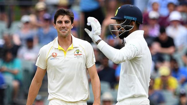 Pat Cummins stares down Lokesh Rahul during the first Test in Adelaide.