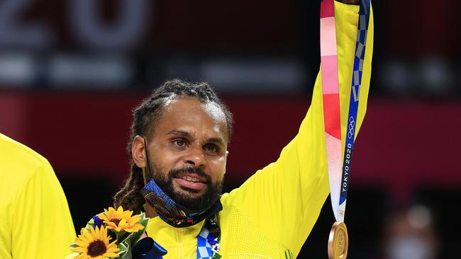 Patty Mills holds a bronze medal for injured Aron Baynes Picture: Adam Head