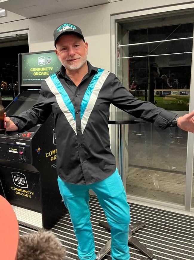 Sean Adams in a self-designed outfit in Newport Power colours celebrating after coaching the Under 14s team to a premiership win in 2023.