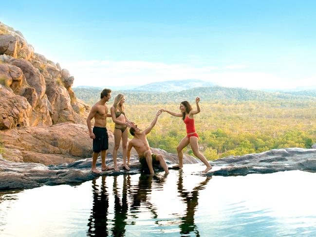 Visitors frolicking at Gunlom.Covering nearly 20,000 square kilometres, Kakadu National Park is teeming with wildlife, home to important Aboriginal rock art sites, and takes in diverse and exotic landscape.