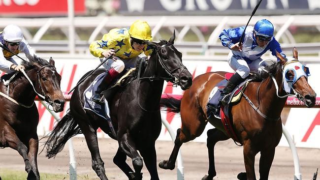 Side Glance (centre) holds out the fas-finishing Dear Demi and Chris Munce to win the Mackinnon Stakes on Derby Day. Picture: Getty Images