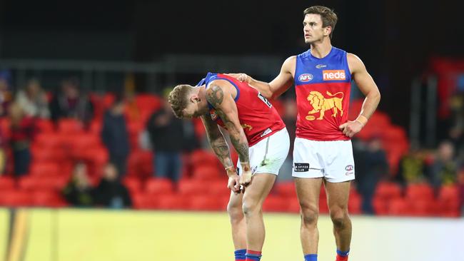 GOLD COAST, AUSTRALIA - AUGUST 04: Jarryd Lyons and Mitch Robinson of the Lions after losing the round 10 AFL match between the Richmond Tigers and the Brisbane Lions at Metricon Stadium on August 04, 2020 in Gold Coast, Australia. (Photo by Chris Hyde/Getty Images)