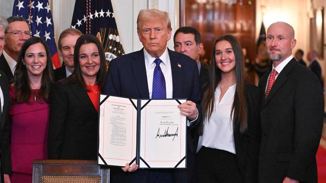 Donald Trump poses after signing the Laken Riley Act in the East Room of the White House. Picture: AFP.