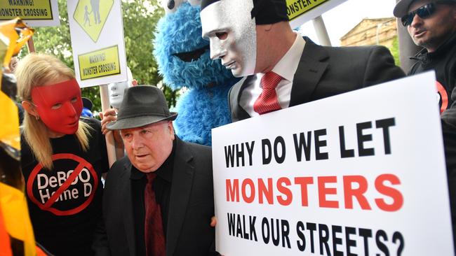 Vivian Frederick Deboo’s final moments of freedom saw him surrounded by his victims and their supporters in a protest outside court. Picture: AAP/David Mariuz