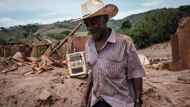 A Brazilian farmer walks through an area devastated by the collapse of Samarco's iron ore waste reservoir. Picture: AFP