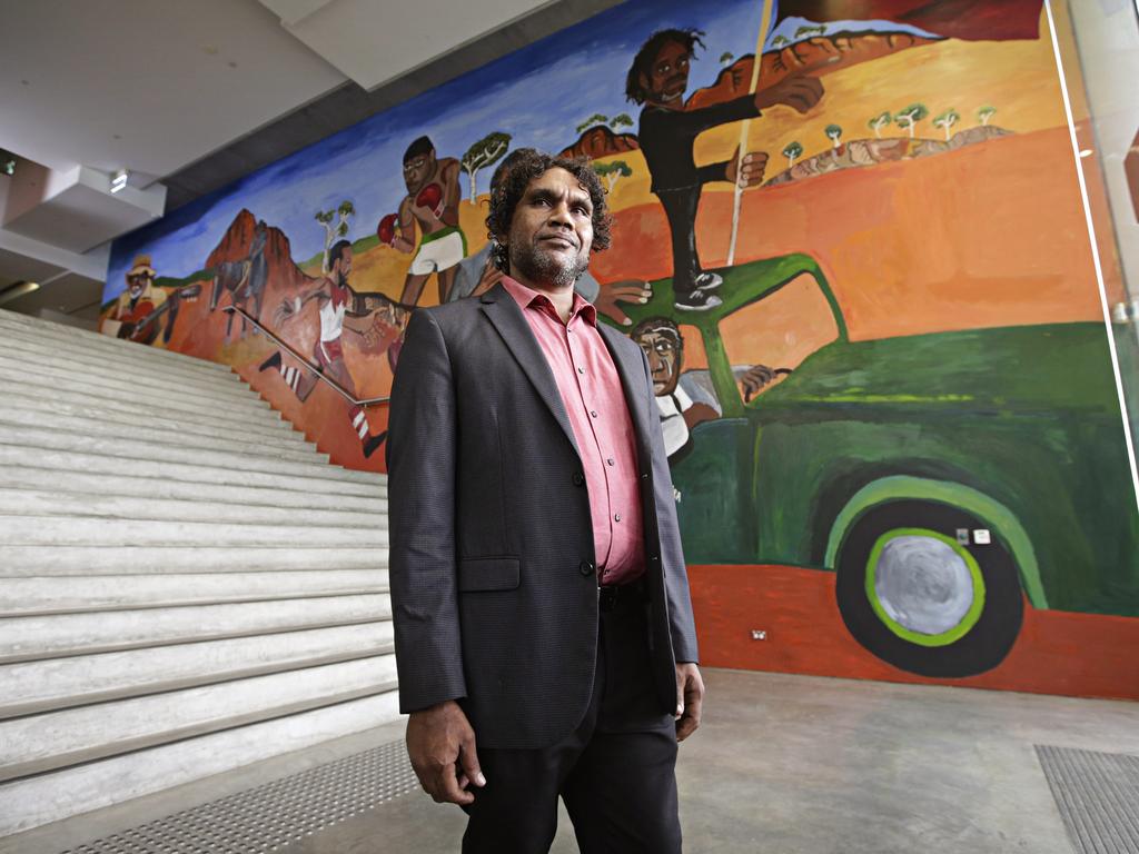 Vincent Namatjira in front of his mural in the foyer of the Museum of Contemporary Art in Sydney. Picture: Adam Yip