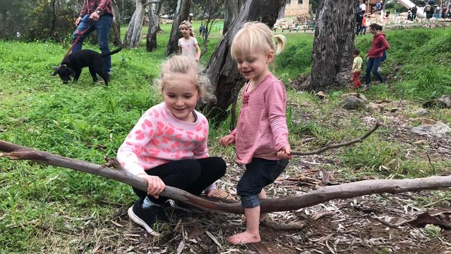 Ali, 5, and Eloise, 1, collecting sticks at the Morialta Conservation Park nature playground.