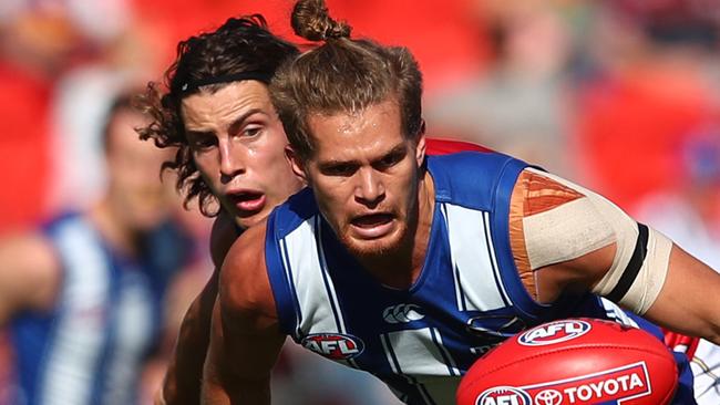 TERRITORIAN Jed Anderson has his Brisbane opponent Jarrod Berry playing peek-a-boo in a 2020 game between Anderson’s North Melbourne and the Lions. Picture: Chris Hyde/Getty Images.