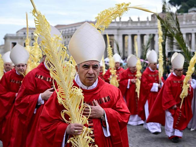 Cardinal Angelo Becciu walked in the procession during a mass for Palm Sunday at St Peter's square in the Vatican earlier this month. Picture: AFP