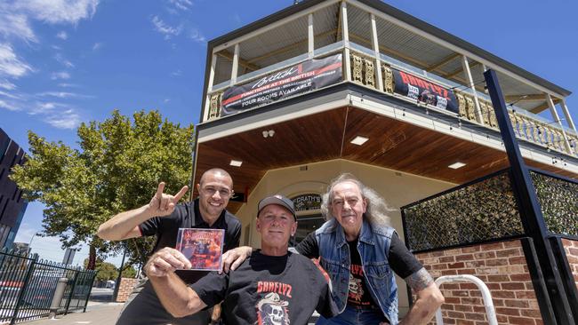 Ash Coulls, super fan Sparky and Barflyz manager Mark Mark Barton at the British Hotel in Port Adelaide. Picture: Kelly Barnes