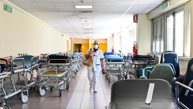 A nurse wearing a protective mask walks between the transportable beds next to the Intensive care unit for patients infected by the novel coronavirus COVID-19 in Rome in April. Picture: Andreas Solaro/AFP