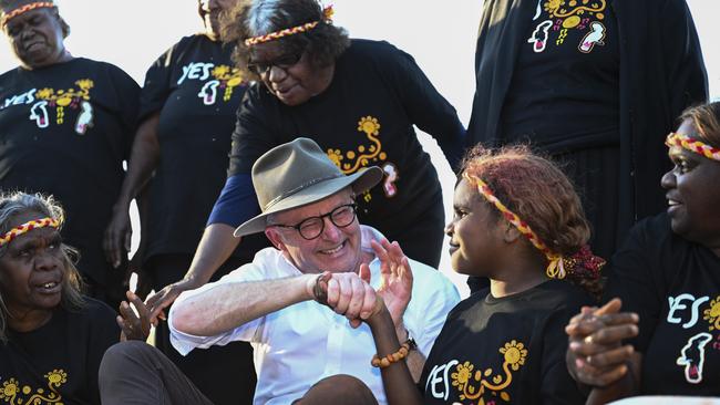 Anthony Albanese greeted traditional owners, Central Land Council delegates and Uluru Statement artists during his visit to Uluru on the eve of the referendum. Picture: NCA NewsWire / Martin Ollman