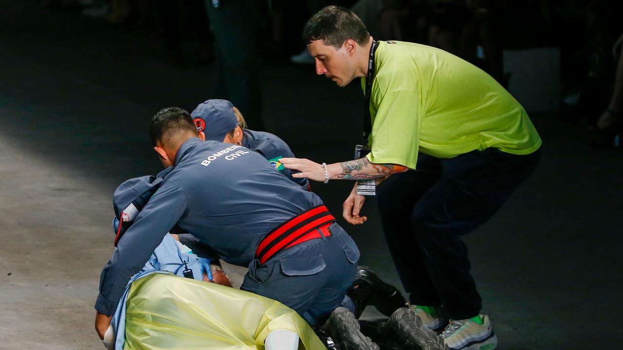 Soares is aided by medics during the Ocksa fashion show. Picture: Getty 