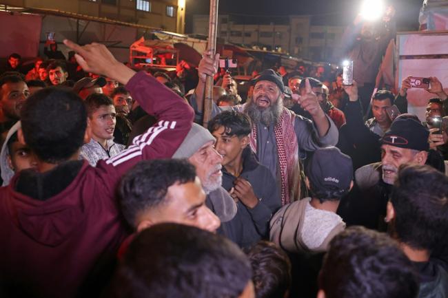 Gazans celebrate along a street in Khan Yunis after news spread of a ceasefire agreement between Hamas and Israel