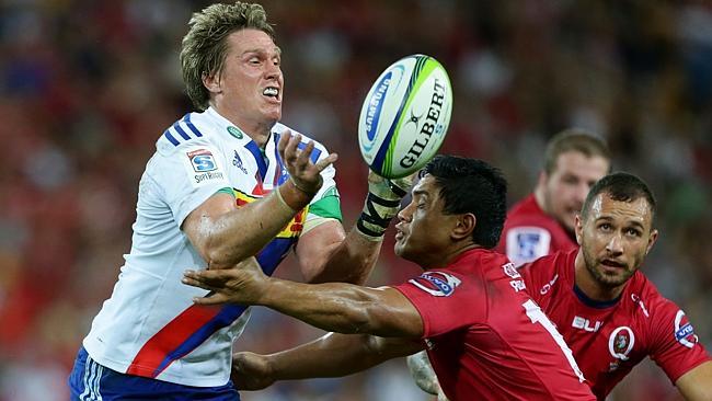 Stormers centre Jean De Villiers and Reds rival Ben Tapuai clash at Suncorp Stadium.