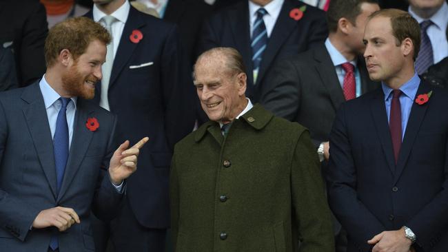 Prince Philip (C) and his grandson's Prince William (R) and Prince Harry (L) during the final match of the 2015 Rugby World Cup between New Zealand and Australia at Twickenham.