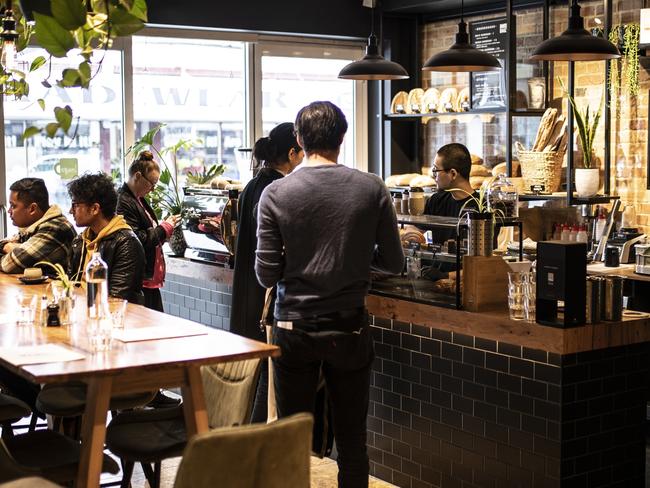 Imago manager Jack Tsai serves customers at the busy Elizabeth St cafe. Picture: Eddie Safarik