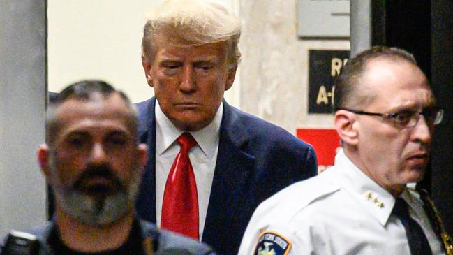 TOPSHOT - Former US president Donald Trump arrives at the courtroom at the Manhattan Criminal Court in New York on April 4, 2023 before his hearing. - Trump is charged with 34 felony counts of falsifying business records stemming from three pre-election hush-money cases, prosecutors said . (Photo by Ed JONES / AFP)