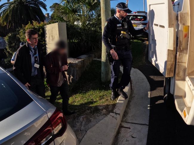 Sex Crimes Squad detectives arrest Brad McLeod, 33, at his Newport home on Wednesday morning. Picture: NSW Police