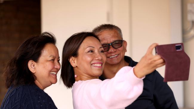 Independent candidate for Fowler Dai Le takes selfies with voters at pre polling at St Johns Park Anglican Church in Cabramatta. Picture: NCA NewsWire / Damian Shaw